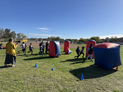 Students enjoying outside activities on the Raider Run obstacle course