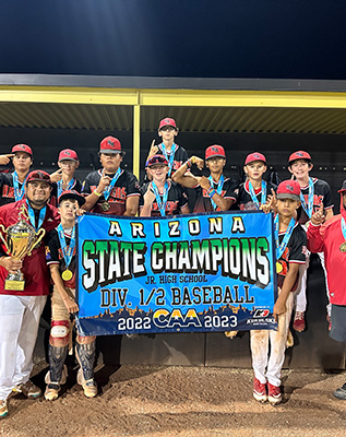Baseball team holding Arizona State Champions banner