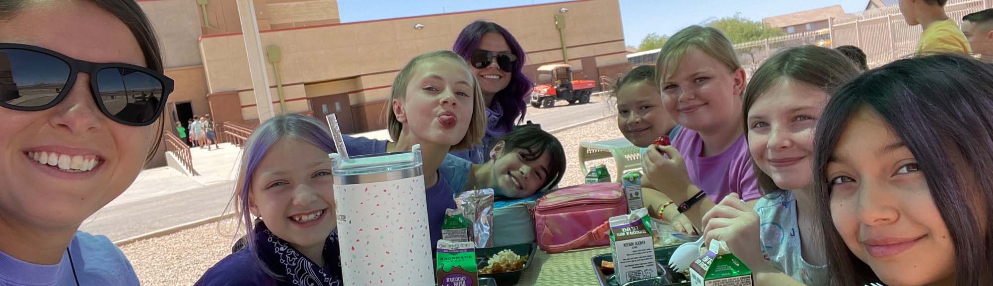 Teacher and student girls eating lunch