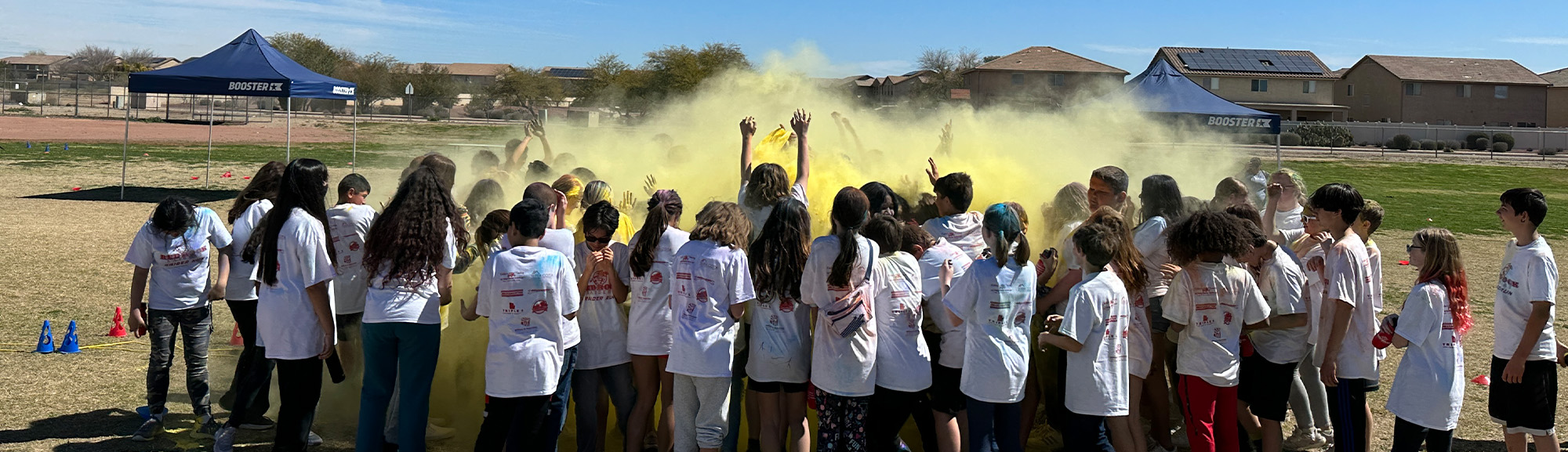 Group of students throwing chalk powder in the air