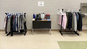 Racks of clothes in a school room